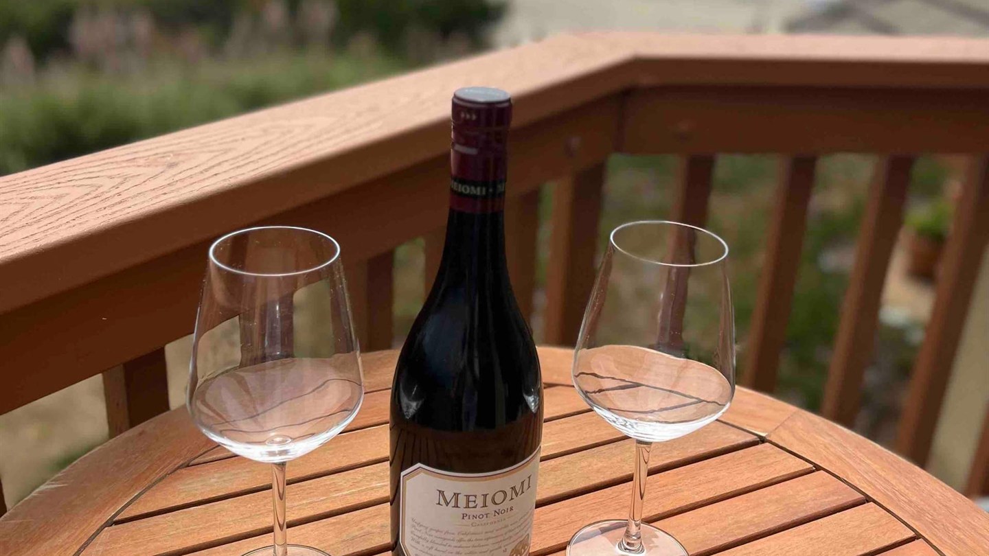 Unit 75 balcony table set for an ocean-view evening